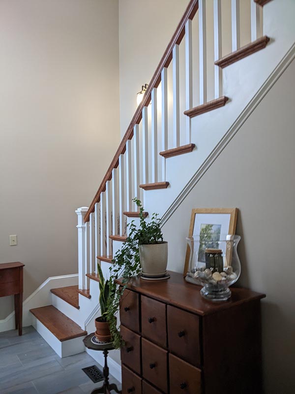 White stairs remodel with stained wood and quality hand craftsmanship. 