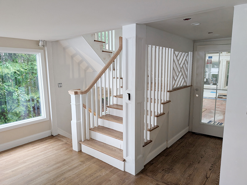 BEFORE the remodel An elegant oak stairwary with curvy oak handrails and custom designed and built lattice panel that compliment the square blisters